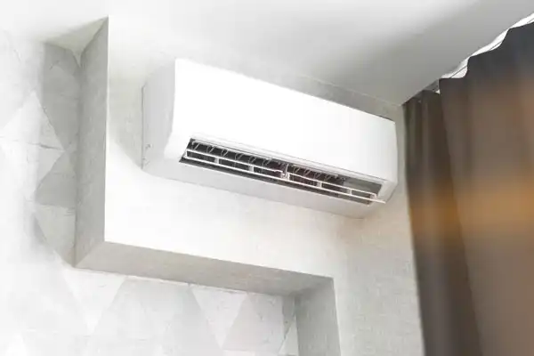 A Childers-installed white wall-mounted air conditioning unit mounted in a room.