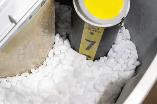 A Childers water softener brine tank filled with white salt pellets, featuring a salt level indicator set to level 7.