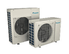 Two white outdoor air conditioning units with protective grilles, positioned side by side on a plain background.
